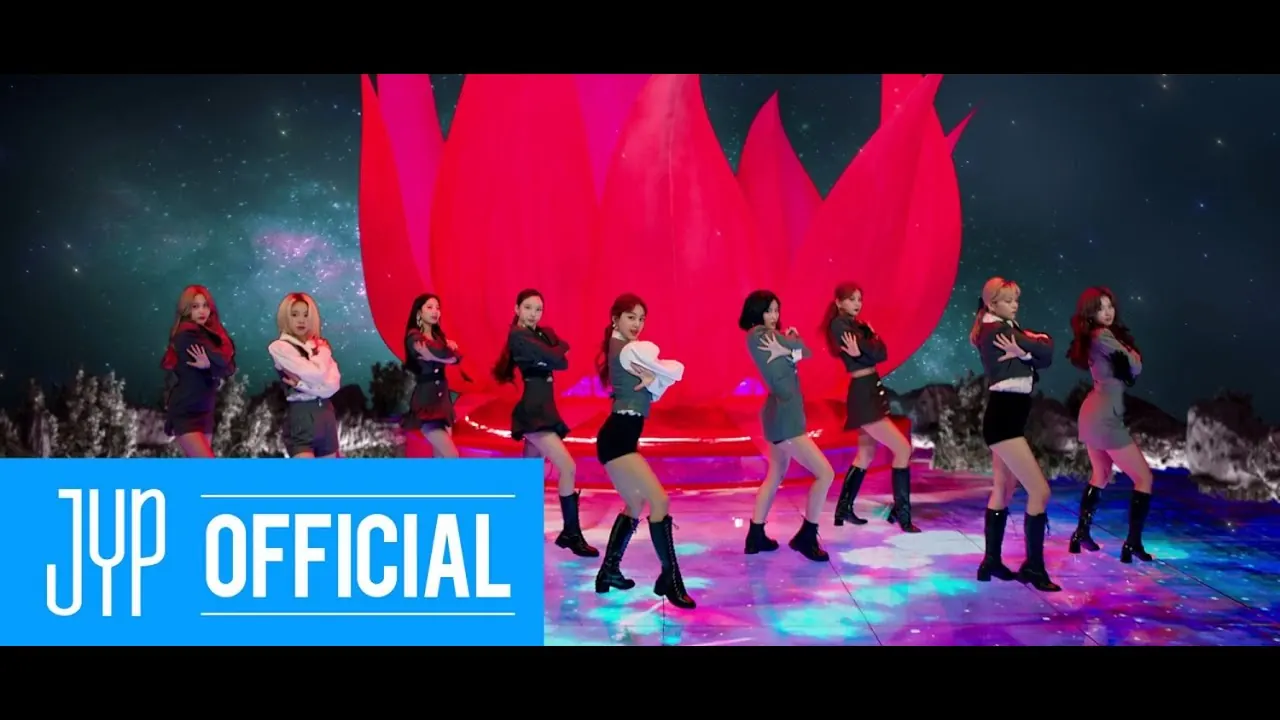 The nine members of TWICE in grey uniforms and black boots, posed in a line in front of a giant red lotus under a starry sky