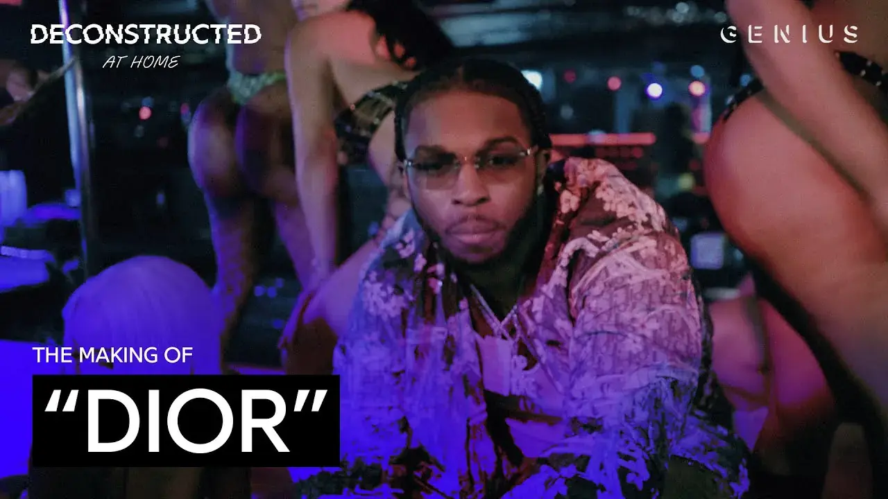 808Melo at a laptop in a studio beside the words The making of Dior and the Genius logo